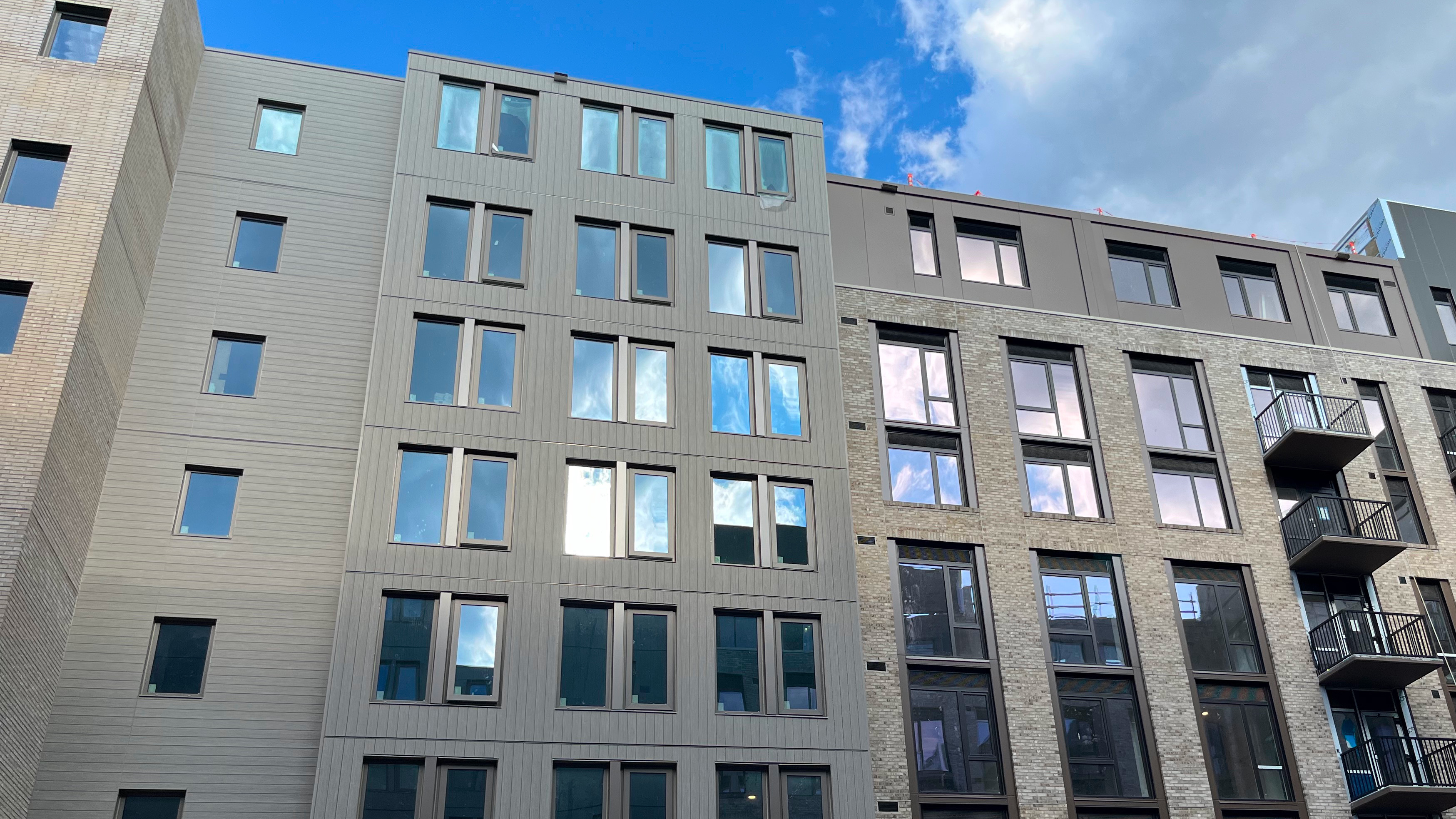 Photo of two adjacent multistory apartment buildings